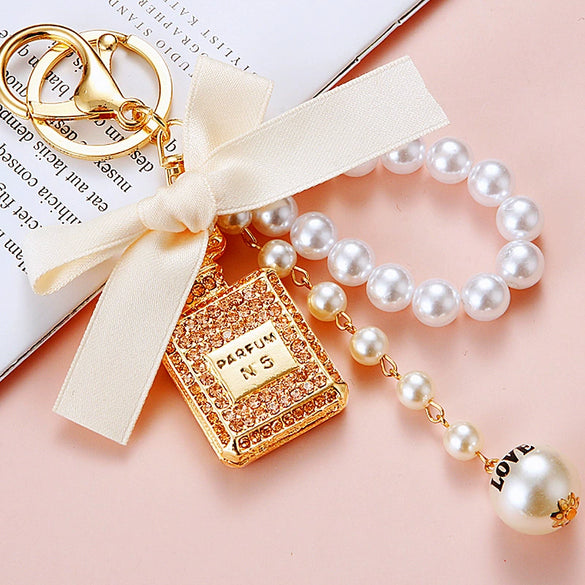 Cute Creative Pearl Bow Perfume Bottle Shaped Metal Keychain For Women As Bag Pendant Or Key Ring Diamond Gifts