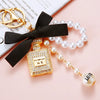 Cute Creative Pearl Bow Perfume Bottle Shaped Metal Keychain For Women As Bag Pendant Or Key Ring Diamond Gifts