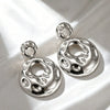 Electroplated Alloy Hollow Round Pendant Earrings With Irregular Wave Pattern And Geometric Statement Design