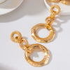 Gold Plated Floral Geometric Interlocking Hoop Earrings With Pleated Brushed Metal Texture And Stainless Steel Posts