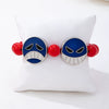 Handmade Alloy Beaded Bracelet With Cartoon Crying Face Pendant Red Beads And Geometric Oil Drip Design For Unisex Wear