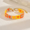 Handwoven Glass And Stainless Steel Heart Bracelet With Colorful Checkered Pattern