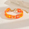Handwoven Glass And Stainless Steel Heart Bracelet With Colorful Checkered Pattern