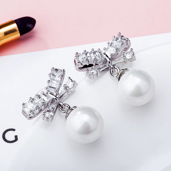 Wholesale Alloy Constellation Diamond Inlaid Zircon Bow Pearl Earrings