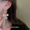 Wholesale Alloy Pearl Inlaid Bow Earrings For Women Silver Needle Light Luxury Personality Style
