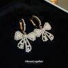Wholesale Alloy Pearl Inlaid Bow Earrings For Women Silver Needle Light Luxury Personality Style
