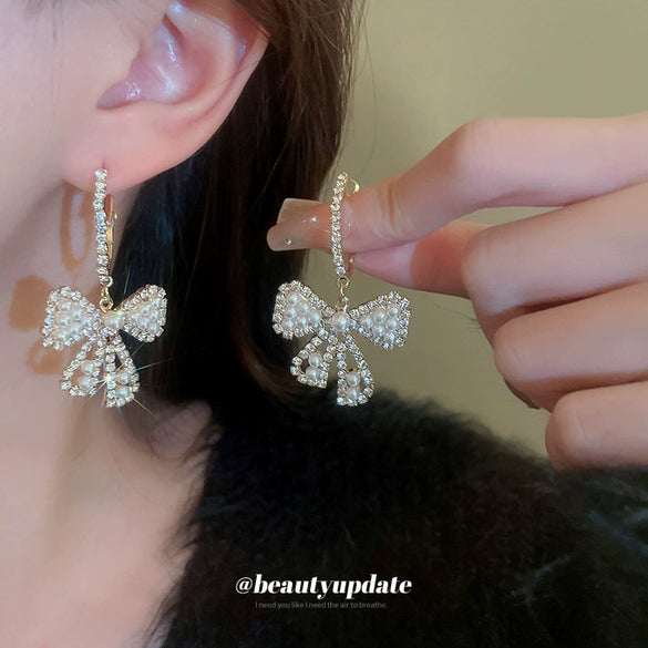 Wholesale Alloy Pearl Inlaid Bow Earrings For Women Silver Needle Light Luxury Personality Style