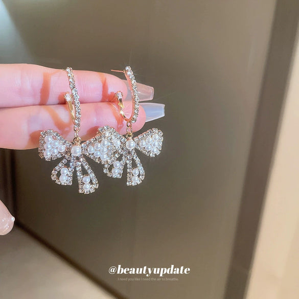 Wholesale Alloy Pearl Inlaid Bow Earrings For Women Silver Needle Light Luxury Personality Style