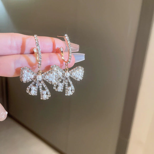 Wholesale Alloy Pearl Inlaid Bow Earrings For Women Silver Needle Light Luxury Personality Style