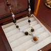 Wholesale Clavicle Chain Artificial Tiger Eye Stone And Pearl Geometric Style Electroplated Necklace