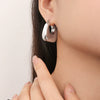 Wholesale Elegant Golden Hollow Small Lucky Bag Earrings In Titanium Steel With Geometric U Shaped Pattern And Electroplating Treatment For Women