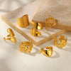 Wholesale Exaggerated Geometric Hollow Flower Stainless Steel 18K Goldplated Asymmetric Ring For Women With Leaves And Wave Pattern