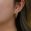 Wholesale Exaggerated Knotted Flat Needle Earrings For Women Golden Titanium Steel Geometric Pattern Electroplated