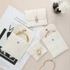 Wholesale Flannel And Velvet Jewelry Storage Bags With Anti Oxidation Buttons And Silk Screen Printing