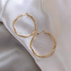 Wholesale Geometric Irregular Circle Twist Flower Earrings Made Of Alloy With Electroplating