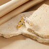 Wholesale Jewelry Stainless Steel Imitation Pearl Inlaid 18K Goldplated Geometric Ring With Cross Devil Gun Design