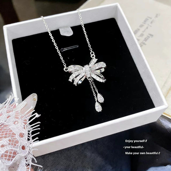 Wholesale Light Luxury Women's Tassel Bow Necklace With Flower Pattern Titanium Steel Oshaped Chain And Copper Zircon Inlaid Pendant