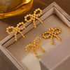 Wholesale Niche Design Round Ball Stitching Bow Style Titanium Steel Earrings Plated With 18K Gold For Women