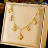 Wholesale Stainless Steel Women's Light Luxury Diamond Water Drop Fourpetal Flower Pendant Collarbone Necklace With Rhinestones And Electroplating