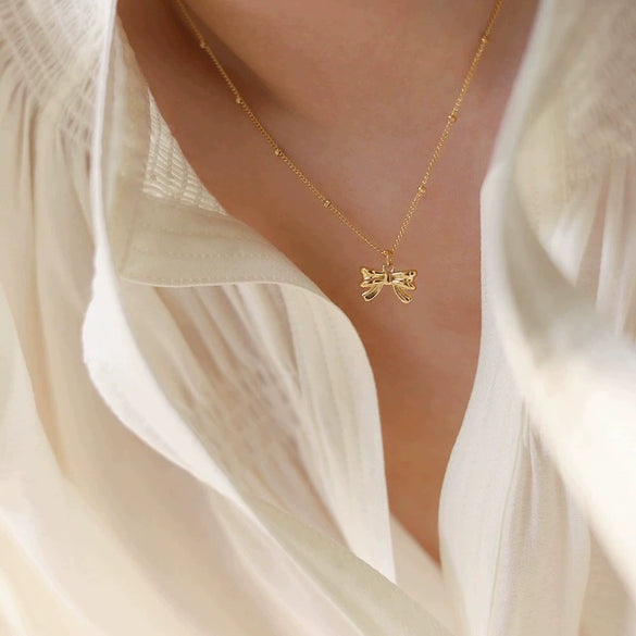 Wholesale Titanium Steel Bow Pendant Necklace For Women With 18K Gold Plating
