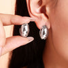 Wholesale Titanium Steel Geometric Goose Egg Shaped Earrings With Electroplating And Retro Temperament
