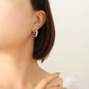 Wholesale Titanium Steel Goldplated Geometric Cshaped Earrings With Inlaid Imitation Pearl Zircon