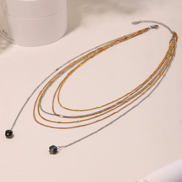 Wholesale Unisex Simple Geometric Ferris Wheel Cutout Volcanic Stone Tassel Titanium Steel Electroplated Necklace