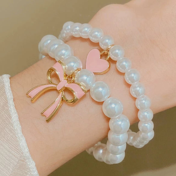Wholesale Women's Alloy Beaded Bracelet With Irregular Imitation Pearl Stitching And Bow Tie Pendant Electroplating Design