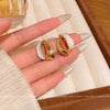 Wholesale Women's Alloy Geometric Curved Texture Earrings With Dripping Glaze And Electroplating