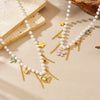 Wholesale Women's Casual Stainless Steel Electroplated Heart Shape Insect Pattern Pearl Strand Beaded Chain Necklace With Imitation Pearl Tassel Pendant