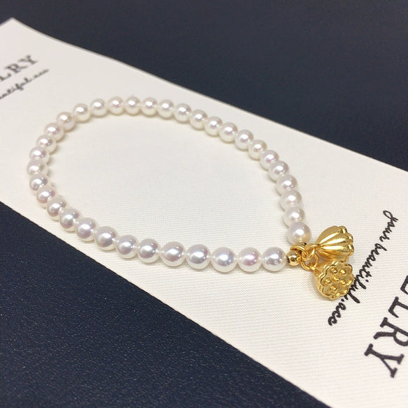Wholesale Women's Copper Freshwater Pearl Elastic Bracelet With Blessing Lock And Lotus Sand Gold Colorpreserving Perfect Circle Shape