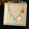 Wholesale Women's Creamy Sweet Style Heart Shape Cartoon Multielement Oil Dripping Love Eyes Letter Round Pendant Stainless Steel Electroplated Necklace With Flat Cross Chain