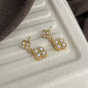 Wholesale Women's Fashion Titanium Steel Flower Four Petal Pearl Embellished Electroplated Earrings