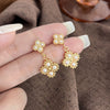 Wholesale Women's Fashion Titanium Steel Flower Four Petal Pearl Embellished Electroplated Earrings