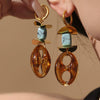 Wholesale Women's Geometric Ferris Wheel Oval Pig Nose Electroplated Stainless Steel Resin Turquoise Earrings