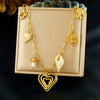 Wholesale Women's Goldplated Stainless Steel Heart Shape And Flower Pattern Hollow Pendant Necklace With Cross Chain