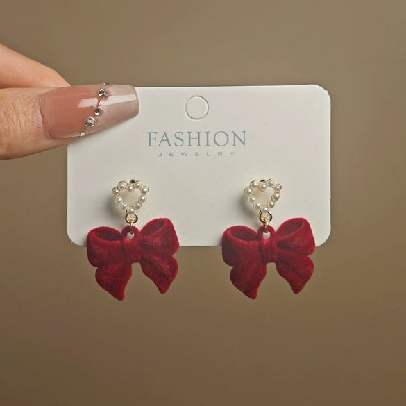 Wholesale Women's Light Luxury Flocking Bow And Heart Zinc Alloy Earrings With Electroplating Treatment