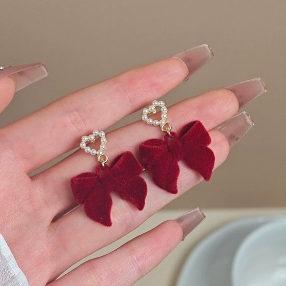 Wholesale Women's Light Luxury Flocking Bow And Heart Zinc Alloy Earrings With Electroplating Treatment