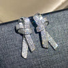 Wholesale Women's Light Luxury Style Copper Earrings With Microinlaid Zircon And Bow Tie Geometric Design
