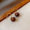 Wholesale Women's Maillard Style Alloy Geometric Tiger Eye Earrings With Electroplating