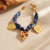 Wholesale Women's Maillard Style Dark Blue Leopard Print Stainless Steel Goldplated Heartshaped Embossed Pendant Bracelet