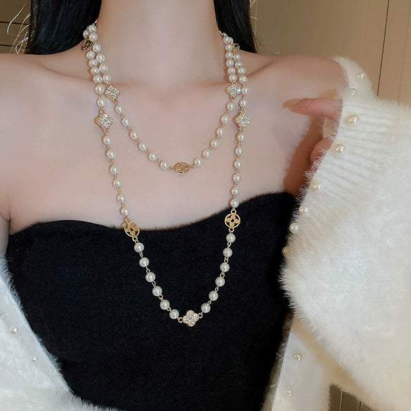 Wholesale Women's Metal And Imitation Pearl Sweater Chain Necklace With Flower Pattern And Light Luxury Style Set With Pearls