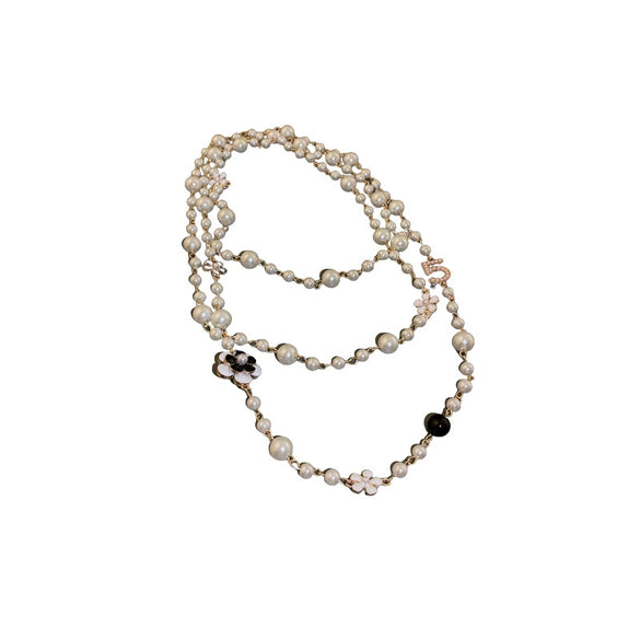 Wholesale Women's Metal And Imitation Pearl Sweater Chain Necklace With Flower Pattern And Light Luxury Style Set With Pearls
