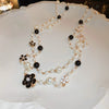 Wholesale Women's Metal And Imitation Pearl Sweater Chain Necklace With Flower Pattern And Light Luxury Style Set With Pearls