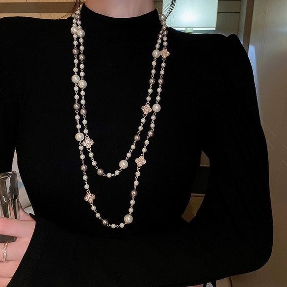 Wholesale Women's Metal And Imitation Pearl Sweater Chain Necklace With Flower Pattern And Light Luxury Style Set With Pearls