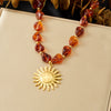 Wholesale Women's Minimalist Retro Goldplated Stainless Steel Beaded Necklace With Asymmetrical Maillard Color Sun Pendant
