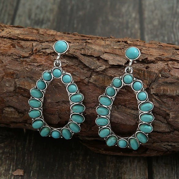 Wholesale Women's Retro Cartoon Drop Shape Hollow Inlaid Turquoise Alloy Earrings