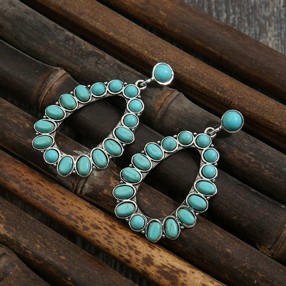 Wholesale Women's Retro Cartoon Drop Shape Hollow Inlaid Turquoise Alloy Earrings