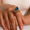 Wholesale Women's Retro Light Luxury Ring In Blue Purple Oil Drop With Diamond Butterfly Design Made Of Stainless Steel With 18K Furnace Vacuum Plating