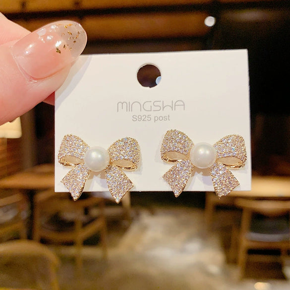 Wholesale Women's S925 Silver Needle Bow Stud Earrings With Micro Inlaid Pearl And Electroplated Alloy Material